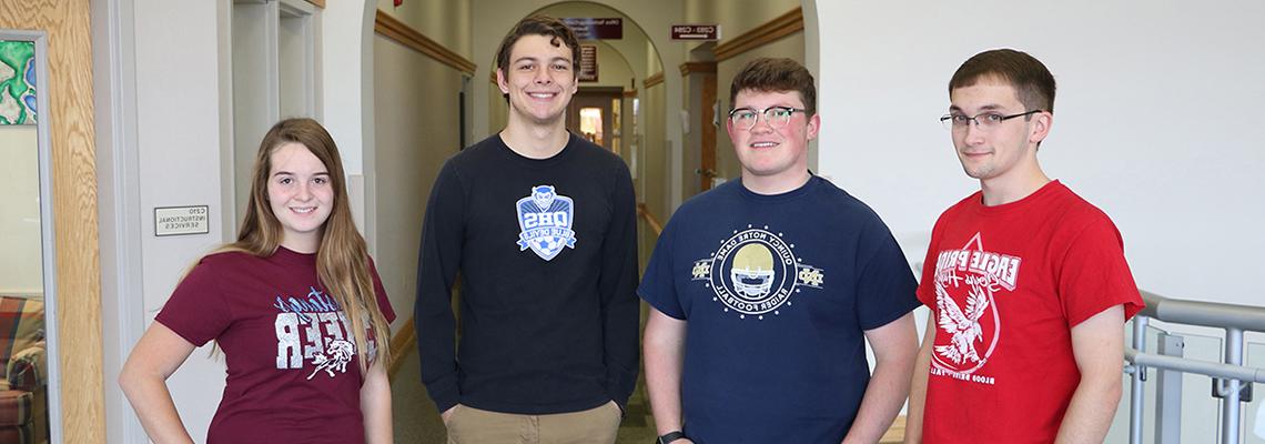 Students smile with their high school tshirts